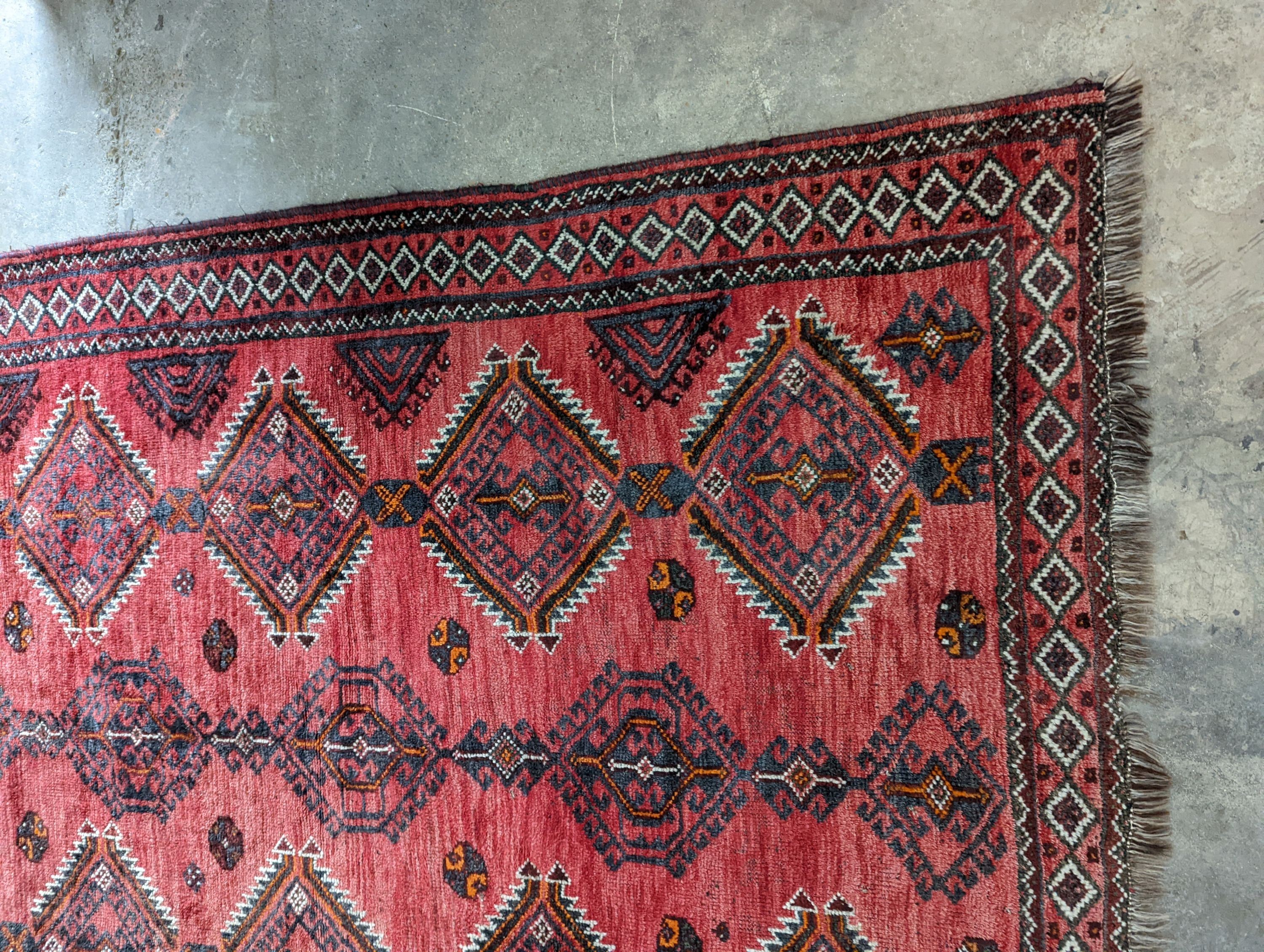 A Caucasian style red ground rug, 255 x 167cm